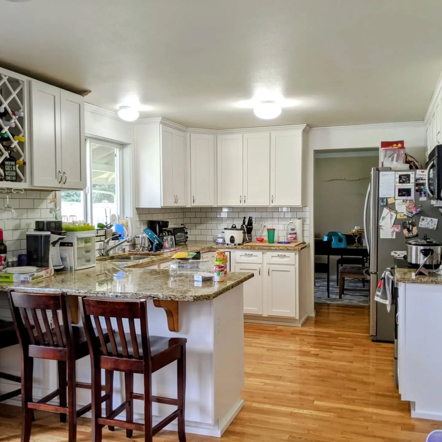 Finished kitchen showing the new wine rack and white cabinets